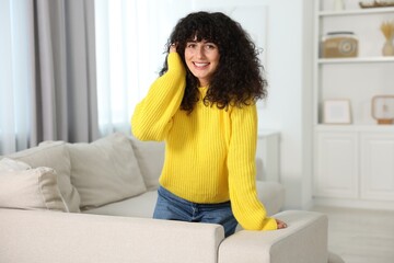 Sticker - Happy young woman in stylish yellow sweater indoors