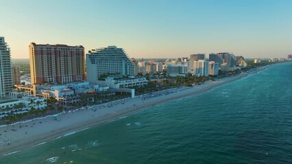 Wall Mural - Aerial view of Las Olas Beach sandy surface with tourists relaxing at warm Florida sunset. Fort Lauderdale city with high luxury hotels and condos. Tourism infrastructure in southern USA