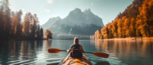 Woman kayaking in lake with beautiful landscape.