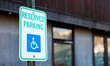 handicap parking sign in blue and white on a paved lot, symbolizing accessibility and inclusivity in urban spaces
