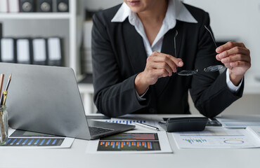 Wall Mural - Tired Asian business woman Stress from paperwork, headaches, sleepiness, boredom from sitting at a desk for a long time. and has office syndrome.