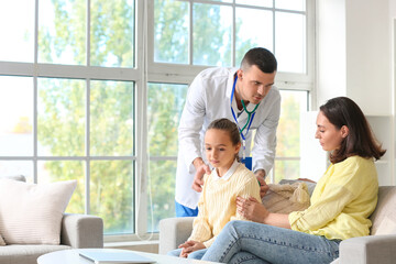 Wall Mural - Male doctor hearing little girl's lungs and her mother at home