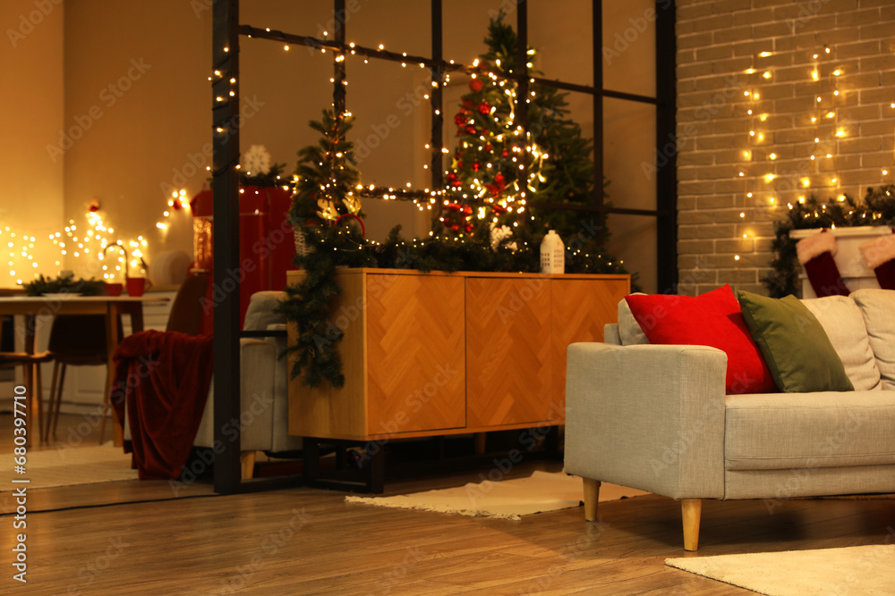 Interior of living room with Christmas lights and sofa