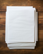 Top Down View Of A Pile Of Old Rustic Empty Blank Papers With Copy Space On A Wooden Desk