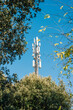 Telephone antenna among the trees, signal repeaters