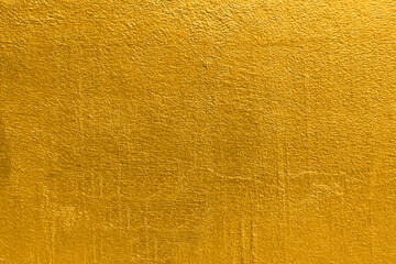 Wall Mural - Gold wall texture background. Yellow shiny gold foil paint on wall sheet with gloss light reflection, vibrant golden paper luxury wallpaper