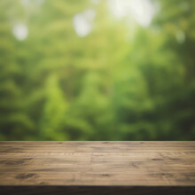 A Wooden Table Top With A Blurred Green Forest Background.
