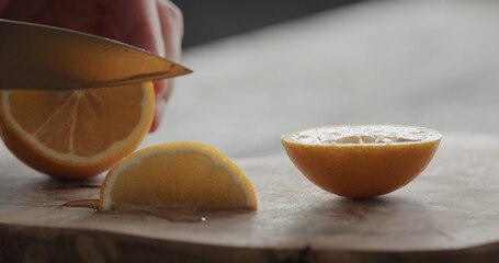 Wall Mural - man cut sweet lemon on olive board