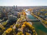 Prince's Island Park Peace Bridge autumn foliage scenery. Aerial view of Downtown City of Calgary. Alberta, Canada.