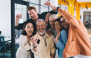 Fototapete - happy group of professional colleagues smiling and shooting video