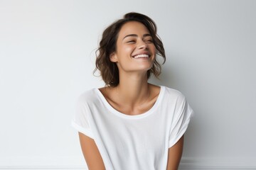 Portrait of a blissful woman in her 30s dressed in a casual t-shirt against a white background. AI Generation