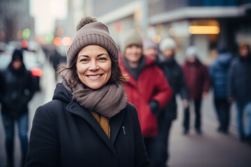 Sticker - Portrait of a smiling woman in her 40s donning a warm wool beanie against a busy urban street. AI Generation