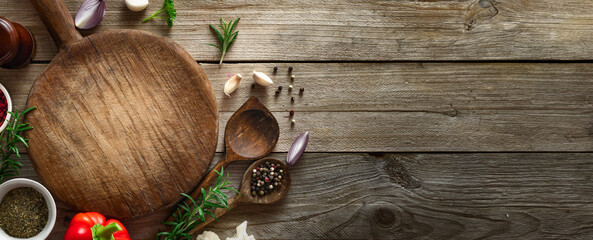 Poster - Cooking background. Old cutting board with spices and ingredients for preparation food on a wooden table top view