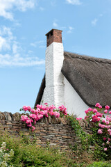 Cottage with chimney and thatched roof