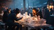 Sculptors and admirers are engrossed in an ice carving display, illuminated by warm lights against a dusk sky at a bustling winter market.