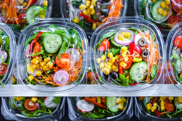 Wall Mural - Boxes with pre-packaged vegetable salads in a commercial fridge