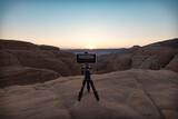 Fototapeta  - Smartphone on tripod in the desert shooting sunset Egypt