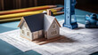 © vyrex short - A model house on a blueprint sheet with a ruler and a pencil next to it.