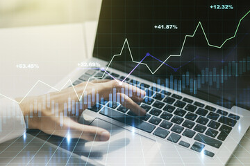 Poster - Abstract creative financial graph with hand typing on laptop on background, financial and trading concept. Multiexposure