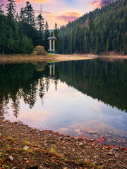 Wall Mural - landscape of synevir lake at sunset in autumn. scenery reflecting in the water. popular travel desti