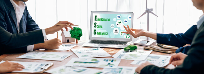 Wall Mural - ESG environmental social governance display on laptop on eco-friendly company meeting with business people implementing environmental protection for clean and sustainable future ecology. Trailblazing