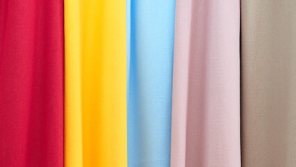 Poster - Mix colorful hanging vertical stripe textile, fabrics, cloths on the rack. Texture of multicolored fabrics close up.