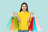 Fototapeta Mapy - Happy woman showing bunch of colorful shopping bags