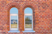 Ancient Red Brick Wall, Daylight, With Two Arched Windows. Horizontal Photo
