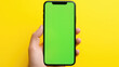 Green screen phone in hand mockup chroma key shopping online yellow background