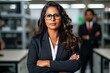 © Qwenergy - A beautiful business woman, the head of a large company, stands in the office with her arms crossed on her chest. Beautiful smiling, wealthy and self-confident, a high-level top manager. Generative AI