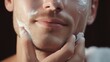 © Irina - Handsome man taking care of face skin after shaving wallpaper background