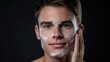 Handsome man taking care of face skin after shaving wallpaper background

