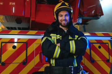 Wall Mural - Firefighter portrait on duty. fireman with helmet near fire engine