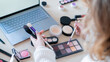 © Михаил Решетников - A faceless woman watches online training from a professional makeup artist on a laptop. Distance learning