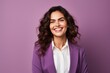 Portrait of happy smiling young businesswoman in violet suit, over violet background