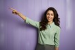 © IgnacioJulian - young brunette woman pointing at a blank canvas on purple, wallpaper, light gray and green