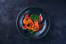 Traditional Fried King Prawns With Fig Pieces, Brown Rice And Wakame Served As Top View On A Design Bowl With Text Space
