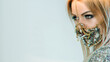 © golubovy - Quarantine party style. Pandemic fashion. Portrait of sensual woman in luxury chain crystal face mask posing isolated on blue copy space background.