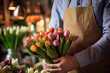 Close-up of tulips bouquet in hands of a man florist