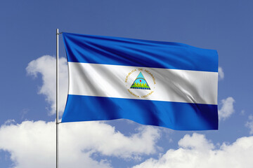 Wall Mural - Nicaragua flag fluttering in the wind on sky.