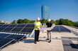 © Westend61 - Two technicians strategizing on the rooftop of a corporate building equipped with solar panels