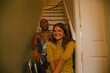© Anna Neubauer - Two young multiracial friends posing in trendy outfits on the stairs at home and laughing