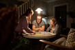 © FOLIO - Man playing board game with his daughters