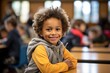 Portrait of smiling boy with book on bench in classroom