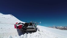 Snow Groomer At Work. Snowcat In The Process Of Preparing Trails On The Mountain