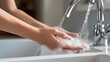 Hand washing poster web page PPT background, a person stands in front of the sink, stretches out his hands and puts them under the faucet