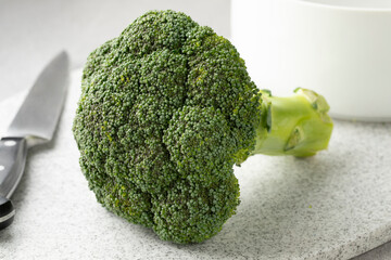 Sticker - Fresh healthy green raw broccoli on a cutting board close up  