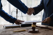 Businessman shaking hands making agreement with lawyer to discuss contract terms In hiring to do court cases, legal concepts, advice and justice.