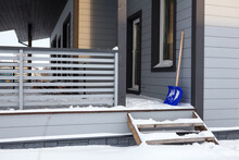 Empty Wooden Terrace With Plastic Snow Scoop, Snowy Stairs And Floor