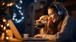 One happy smiling  young woman communicates with friends on laptop, wishes them Merry Christmas and shows them his golden retriever dog at home. Blurred festive christmas background. Copy space.